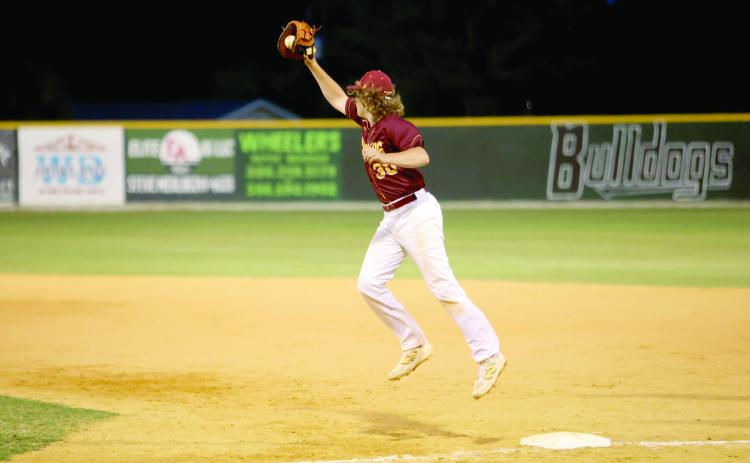 Liam Reeves catches a high throw at first base.