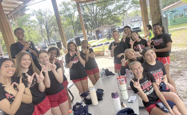 The Hilliard cheerleaders help beautify Hilliard.
