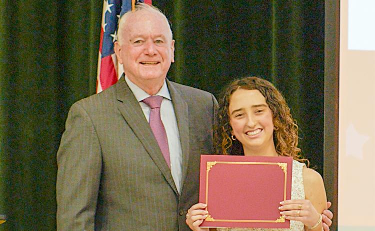 HMSHS senior McKenzie Roberts receives a $10,000 scholarship for writing an award-winning essay.