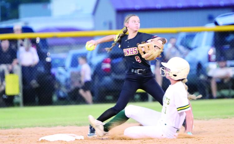 Lauren Rosepiler gets the out and throws the ball in as the Lady Warriors host Yulee May 6.