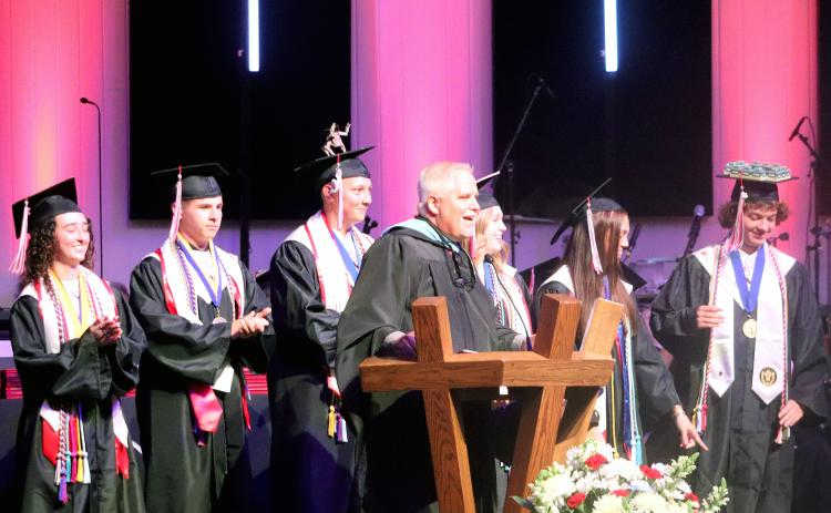 Joined by senior class officers on stage, Principal John Crawford speaks at graduation Thursday.