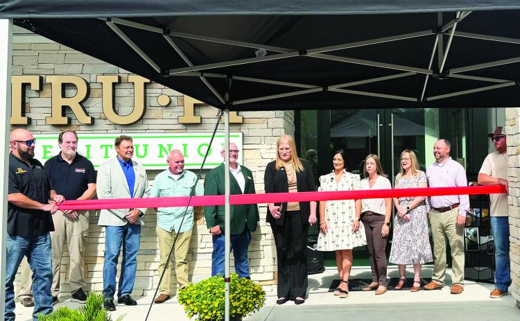 TRU-FI Credit Union officials and community members participate in a ribbon-cutting ceremony celebrating the grand opening of the credit union’s newly built Callahan branch Tuesday. The former branch was torn down after construction completed. Photo by Britney Fletcher West