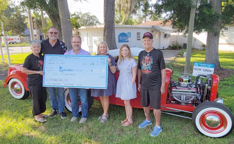 The annual Memorial Day Rod Run 4 Kidz, a mission of Callahan Methodist Church, raised $10,000 for Barnabas Center. Pictured left to right are Cheryl Mangold, Brad Mangold, Pastor Bodie Riddle, Barnabas President and CEO Jamie Reynolds and Community Engagement Manager Trish Thompson, and Jim Mangold. The annual fundraiser is held on the church grounds on the Saturday of Memorial Day weekend, drawing a crowd each year. Photo by Amanda Bishop