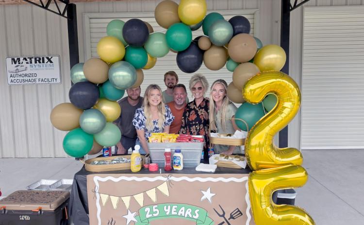 Neal and Marty Cochrane and family celebrate Cochrane Collision Center’s 25th anniversary Thursday. They offered hot dogs and treats to everyone who stopped by. The business specializes in repairing wrecked vehicles and is located at 617473 Brandies Ave., Callahan. Photo by Amanda Bishop