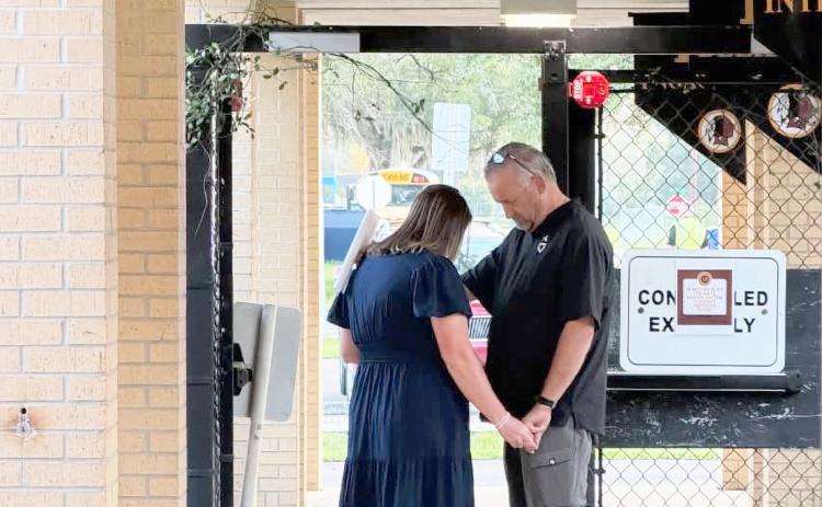 West Nassau Principal Melissa Johnson joins in to pray over West Nassau High School, students, and staff. Submitted