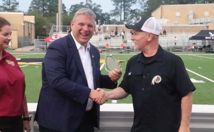 Craig Smith shakes West Nassau High School Athletic Director Richie Knott’s hand Saturday as he’s inducted into the school’s Hall of Fame.