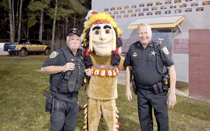 Jimmy Hall and Stephen Johnson, Nassau County Sheriff’s Office reserve deputies, join the Warrior mascot after signing off with NCSO dispatch for their final time Feb. 27.
