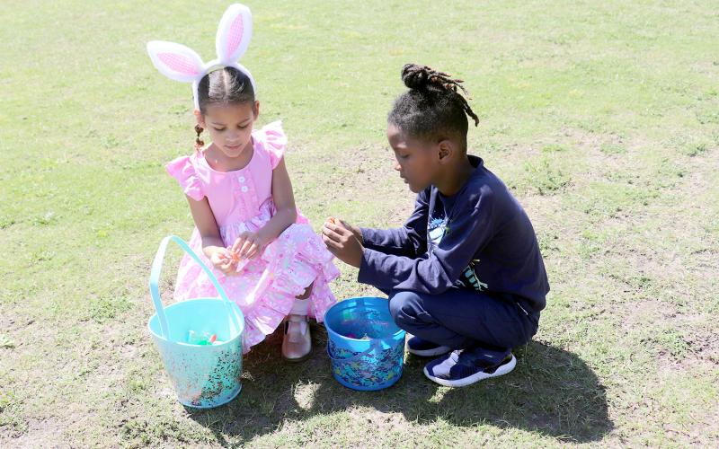 Cousins Donlayah Williams, 7, of Hilliard and Isaiah Williams, 7, of Folkston, Ga. open their Easter eggs after an egg hunt at Hilliard Middle-Senior High School Saturday. 